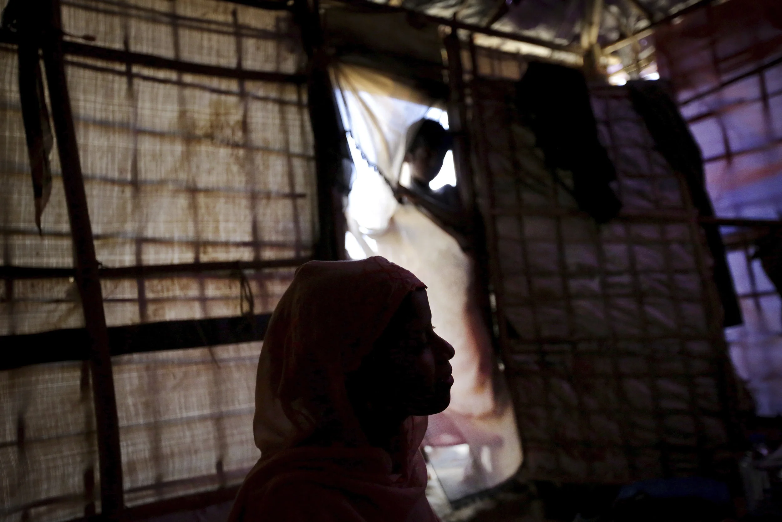 R, a 13 year-old Rohingya girl, is seen in silhouette in her tent in Kutupalong refugee camp in Bangladesh. Photo Credit: Wong Maye-E/AP Photo.