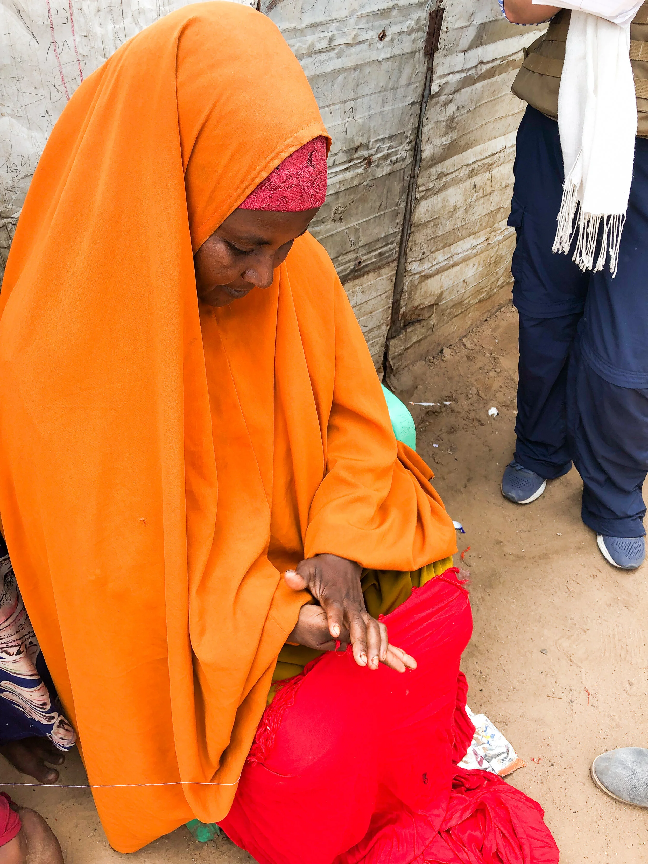 This woman has been making scarves for 30 years to make a living in Mogadishu. She sells them in the local market and makes $1.50 for 30 scarves. Photo Credit: Refugees International.