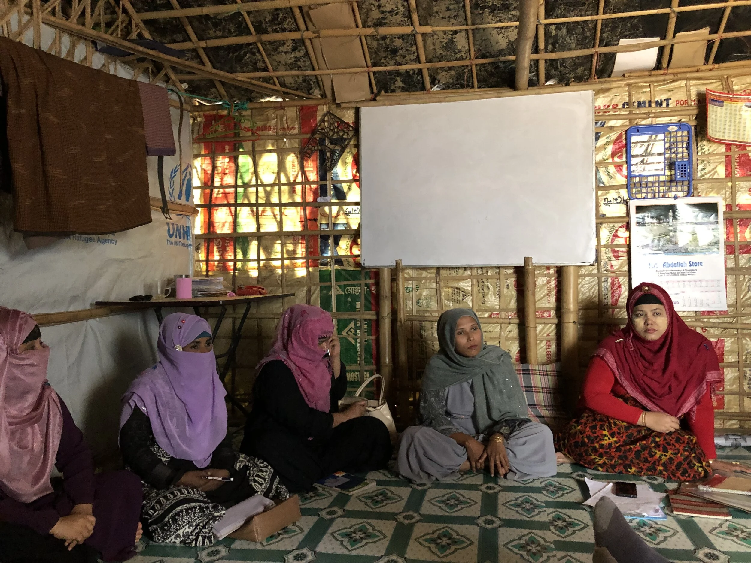 The Refugees International team met with, Chekufah, right, as she hosted a meeting of her Women’s Empowerment and Advocacy Network.