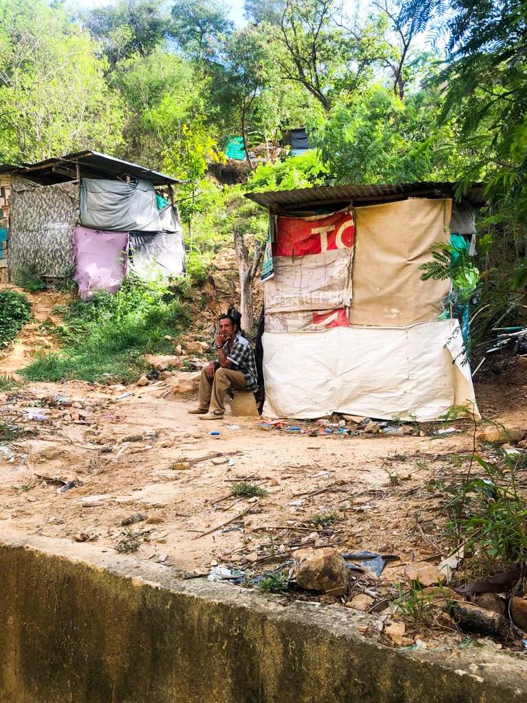 A man sitting in an informal settlement on the outskirts of Cúcuta, Colombia. Photo Credit: Refugees International.