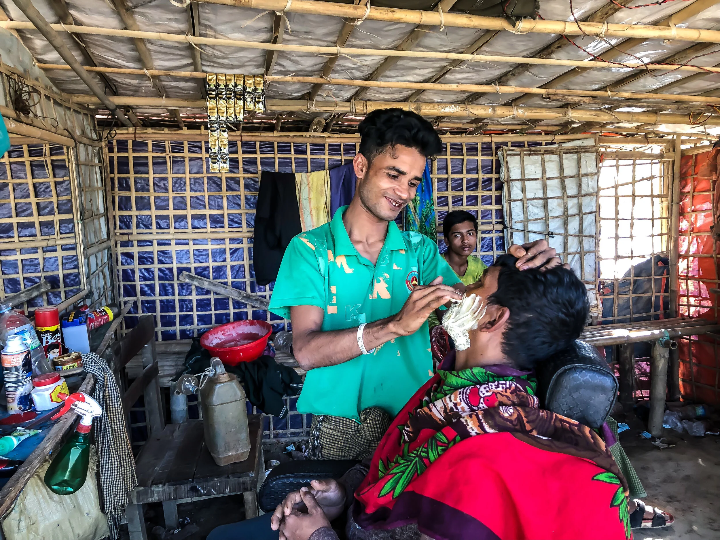 A barber working in the Rohingya refugee mega-camp. Photo Credit: Refugees International.