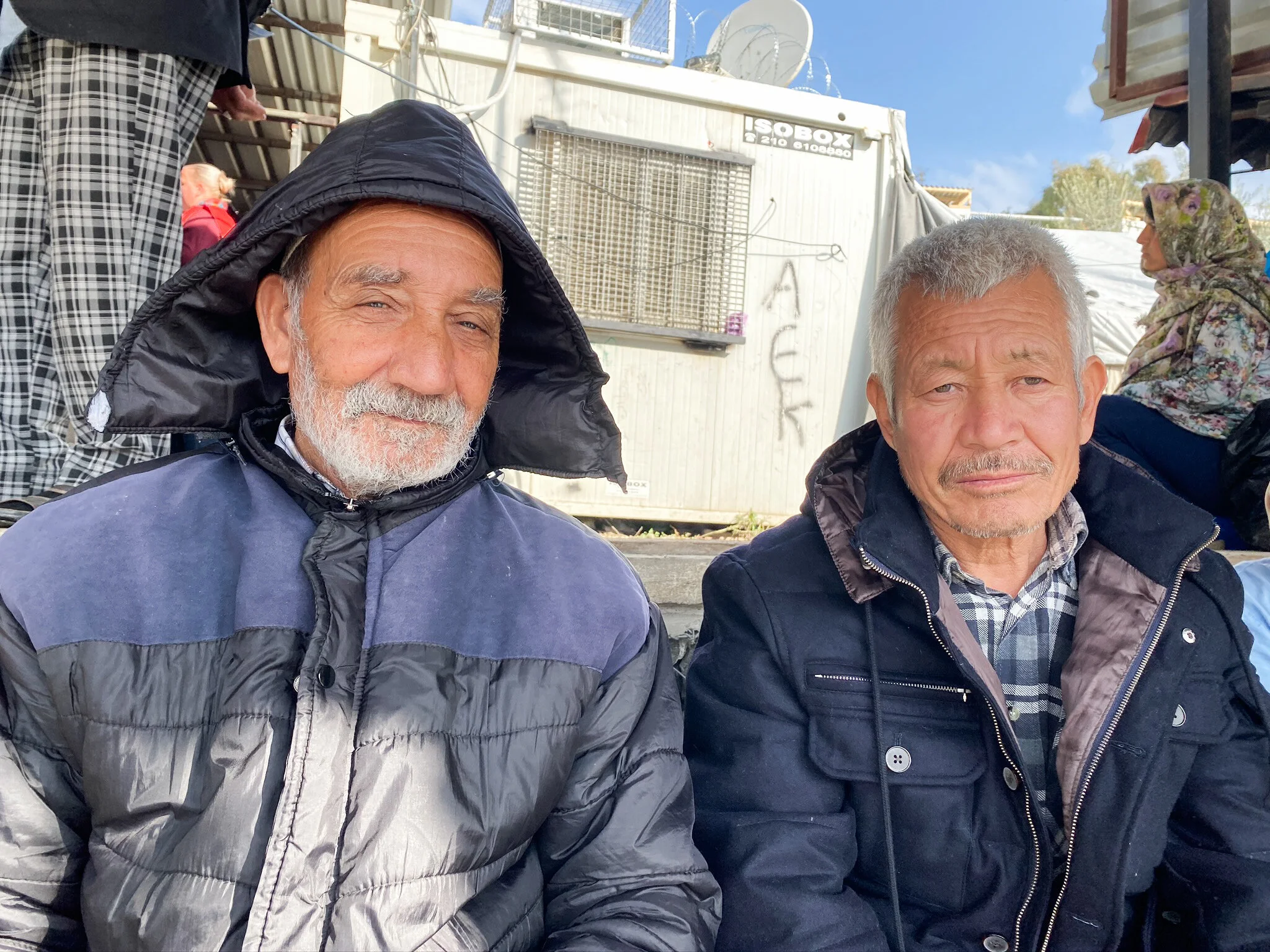Elderly Afghan asylum seekers waiting for food distribution in Moria Reception and Identification Center. Photo by: Devon Cone.