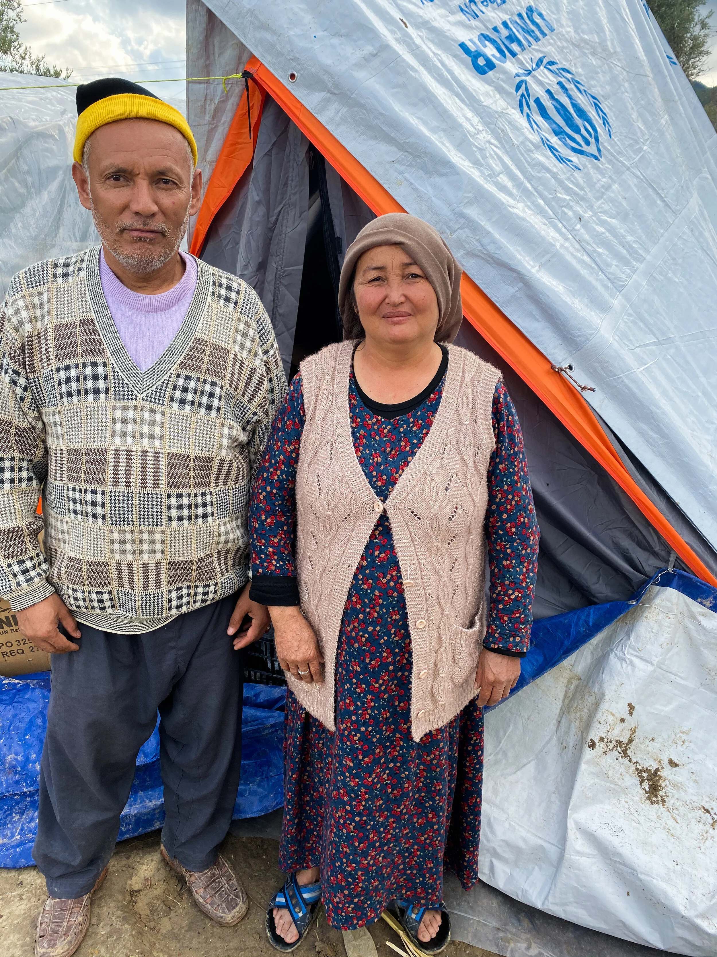 Afghan couple outside of their tent on the island of Chios near the Vial Reception and Identification Center. Photo Credit: Devon Cone.