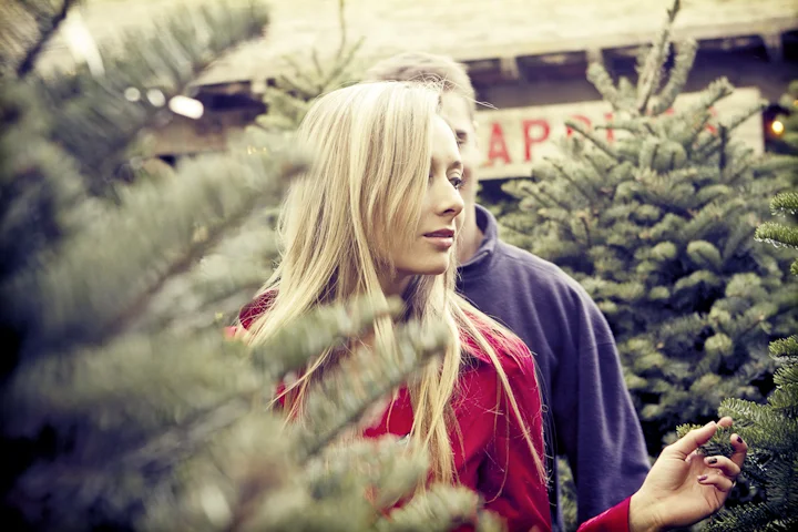 Young couple picking out a Christmas tree.