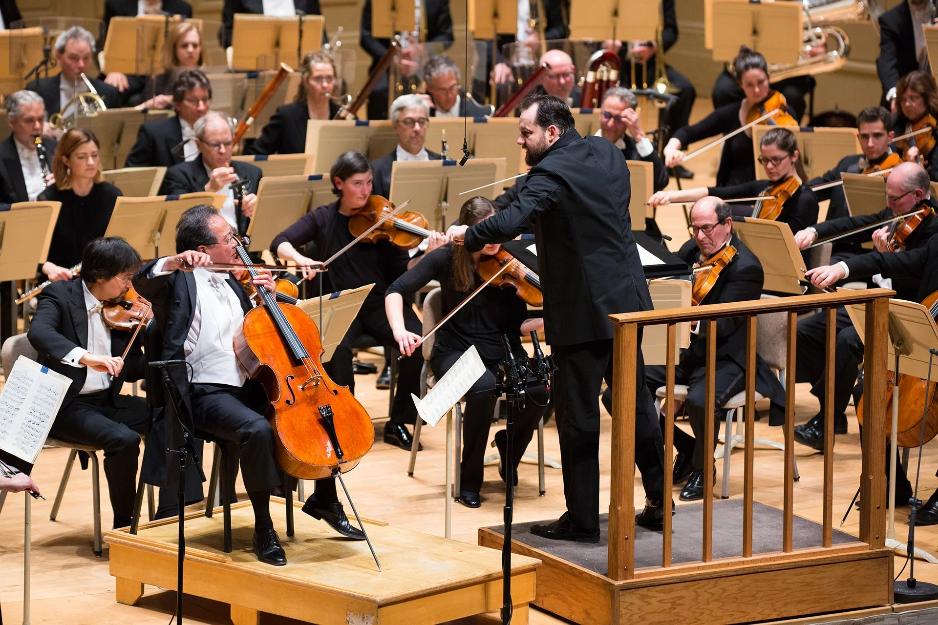 The Boston Symphony Orchestra, Andris Nelsons conducting, with soloists Yo-Yo Ma (left) and Steven Ansell (right of Nelsons), Thursday, March 29 at Symphony Hall. Robert Torres photograph