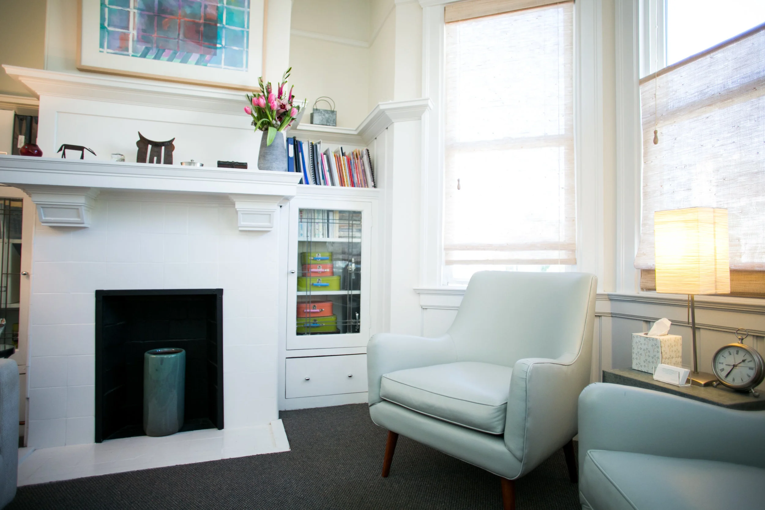 Dana Iscoff's office, with a chair next to a bay window and a fireplace