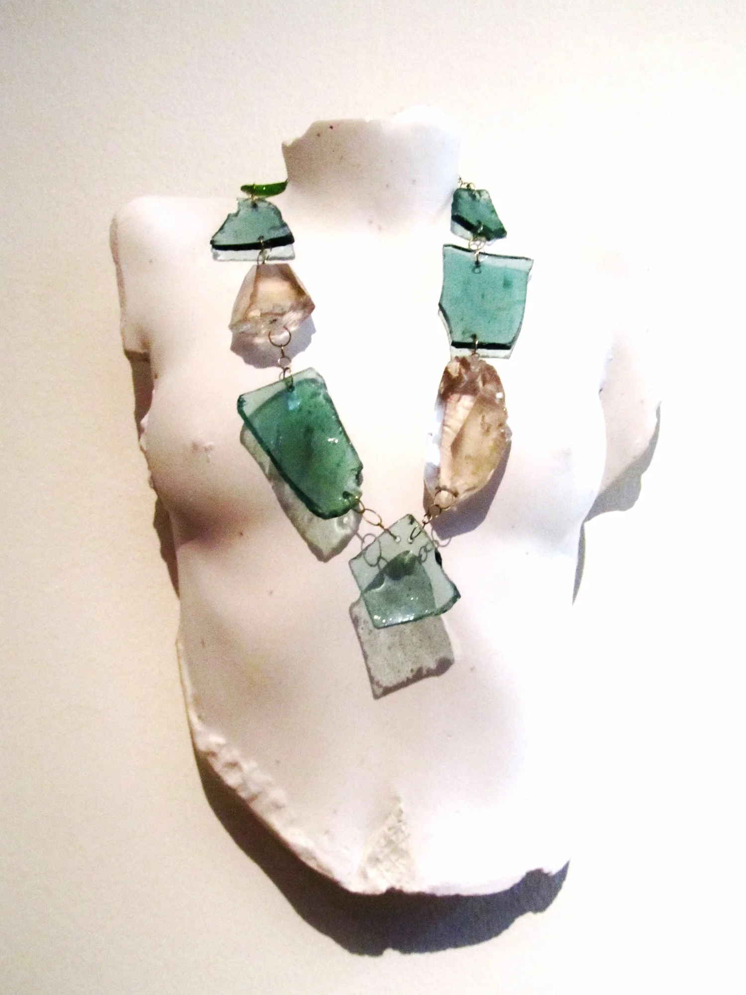 Rose Quartz & Bottle Chain Necklace 2014, rose quartz, bottle glass, gold. These objects look dangerous, but the edges are smoothed to be safe to wear.