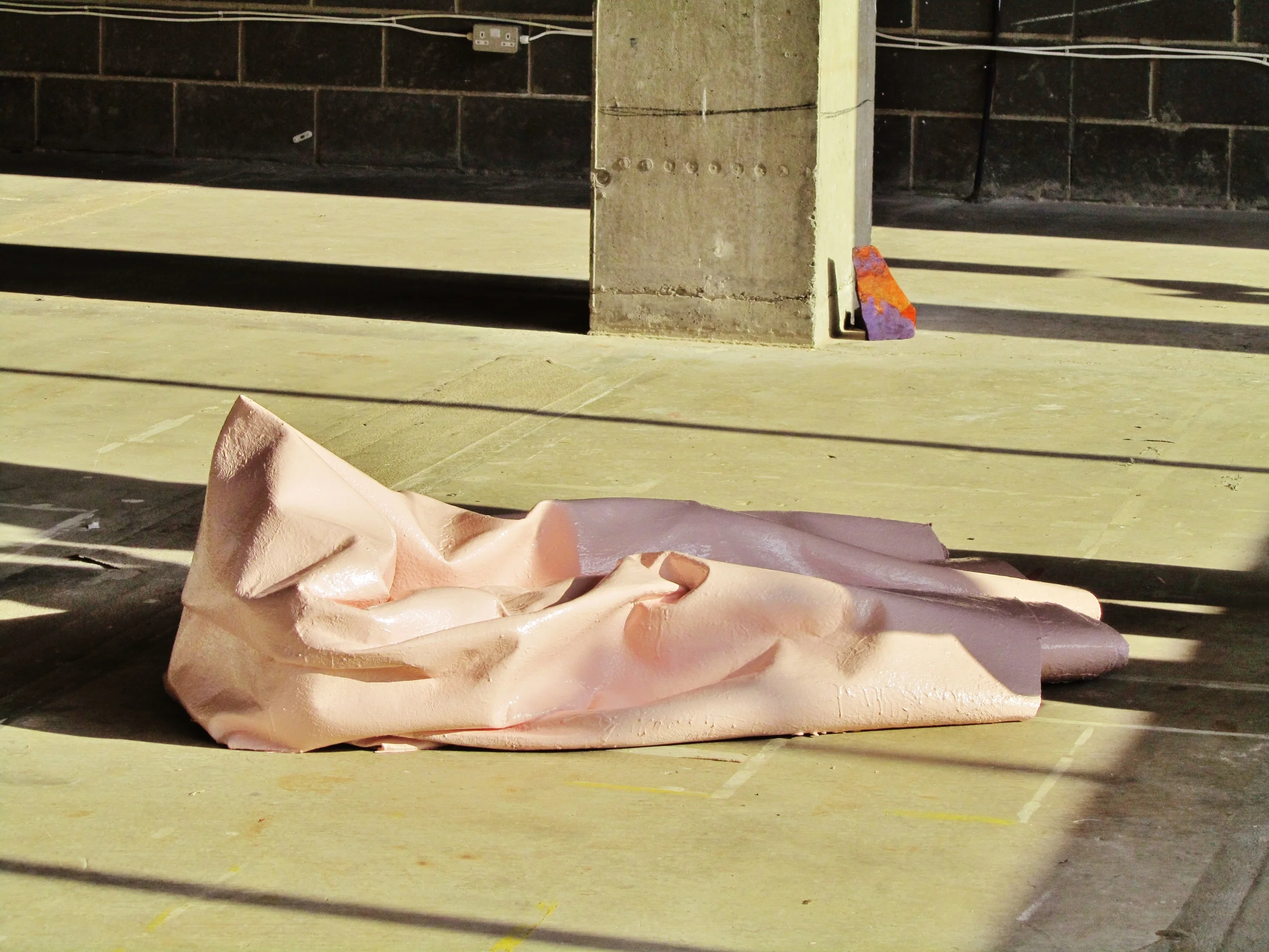 The pink painted carpet forms part of Jo mcGonigal's painting. Lisa Denyer's Orange and Purple painted stone 2014 rests discreetly against a pillar. 