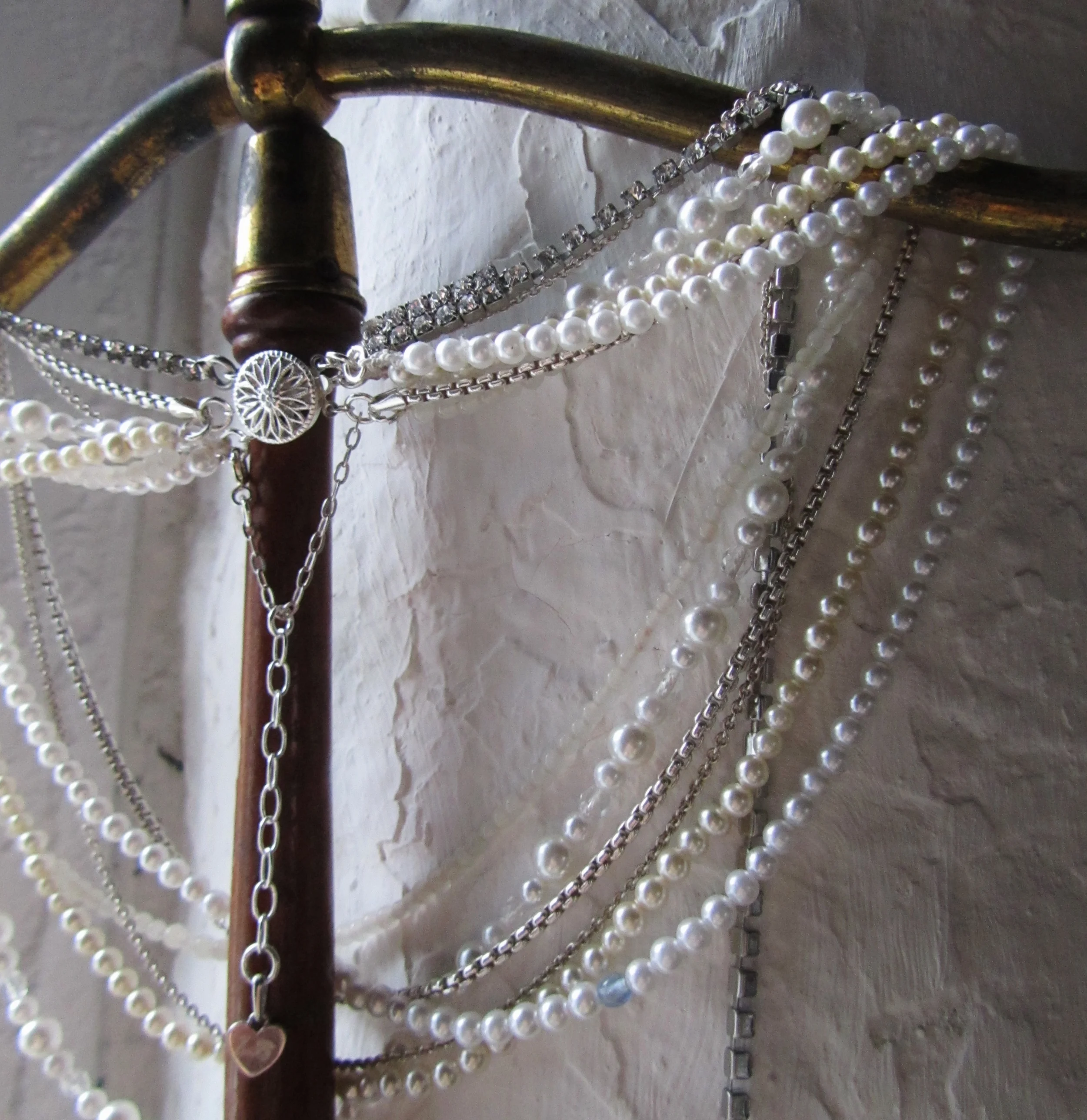 A mixture of vintage beads and sterling silver chain with a hand engraved detail on the safety clasp to match the bridesmaid necklaces with the brides new initials as a secret personal touch to mark the occasion.