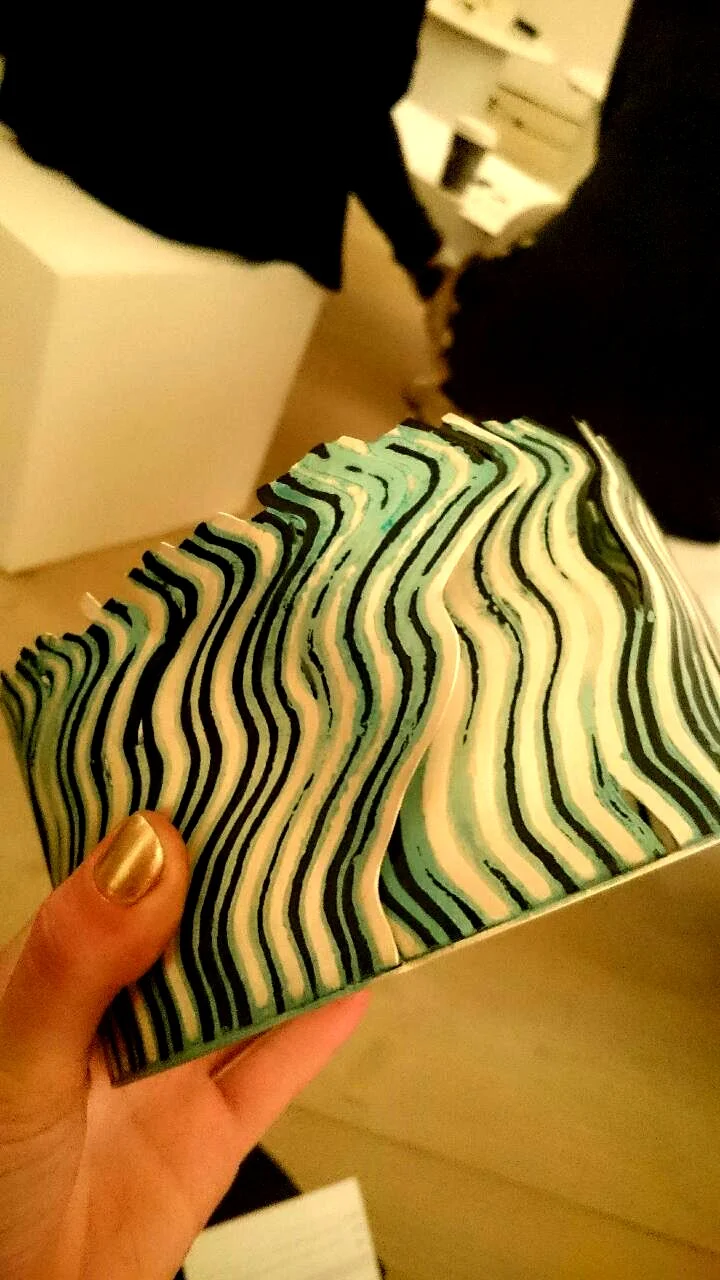 Hazel Thorn creates her own material through fusing rods of silver and gilding metal, creating an alloy, seen as the the third green stripe.