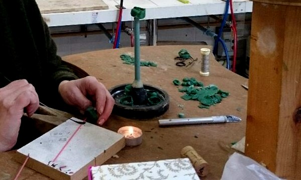 Spruing-up with thin rods of wax makes a tree like structure which will allows the molten metal to flow into and fill the cavities.