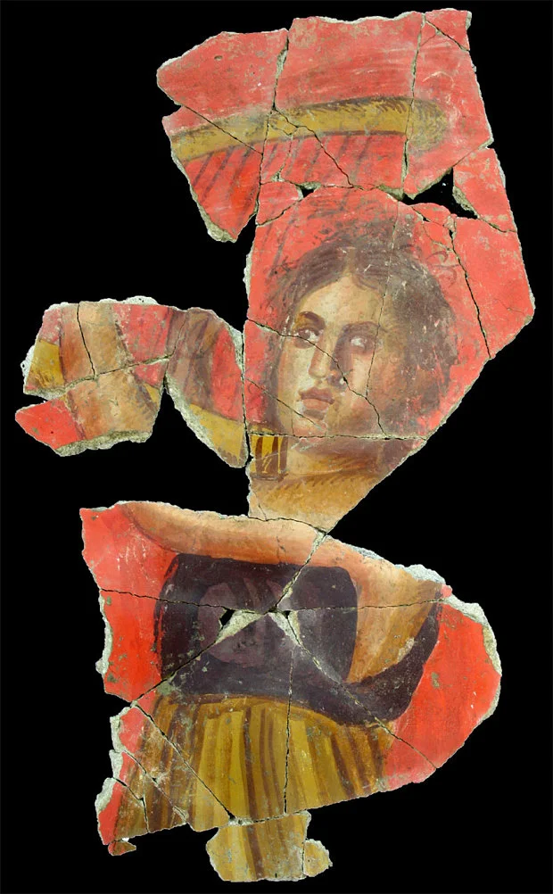 The figure is a lady harpist, painted in vivid pigments by the Ancient Romans and recently found in Arles.