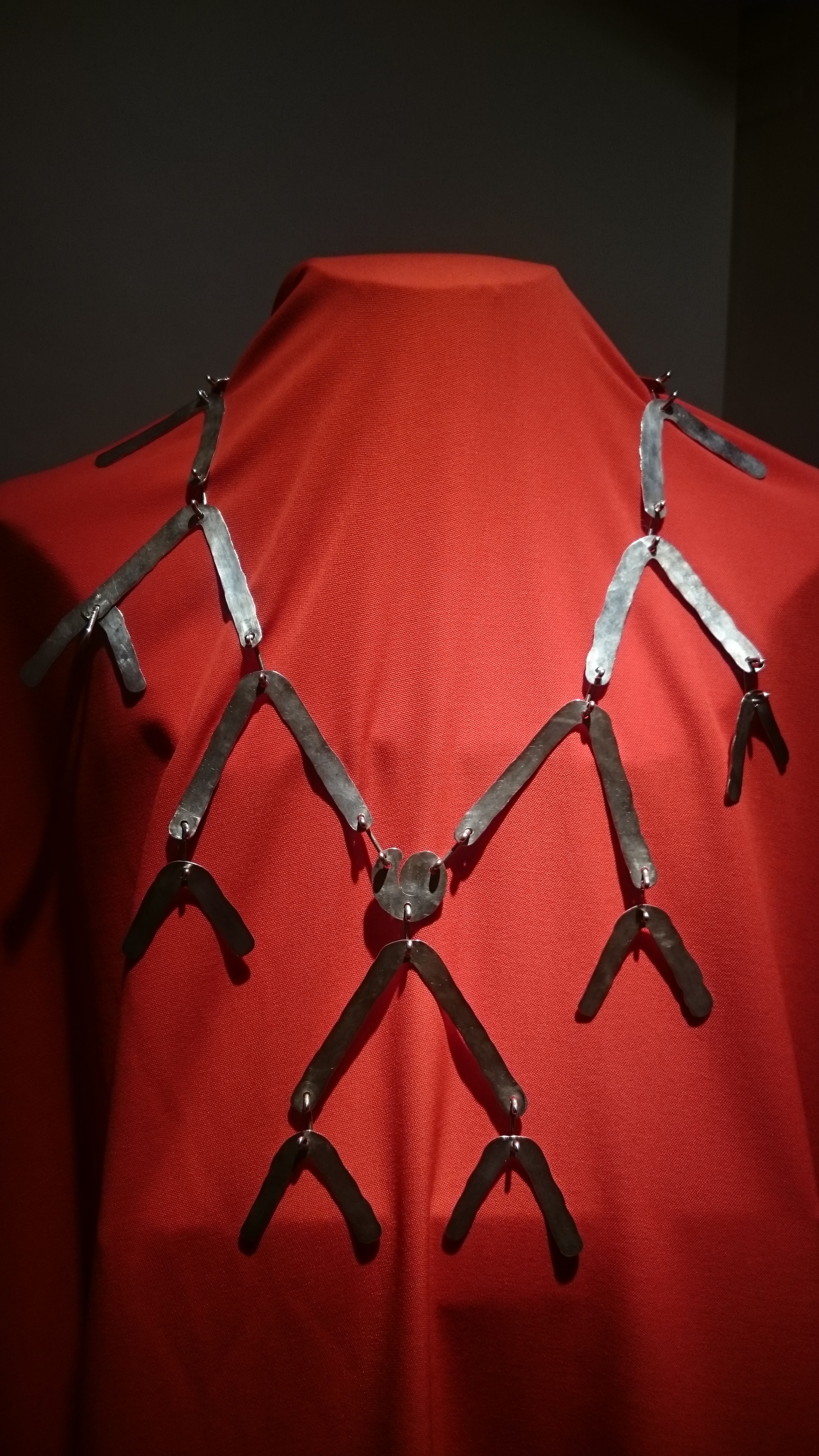 Connected components fit over the body in a Calder necklace