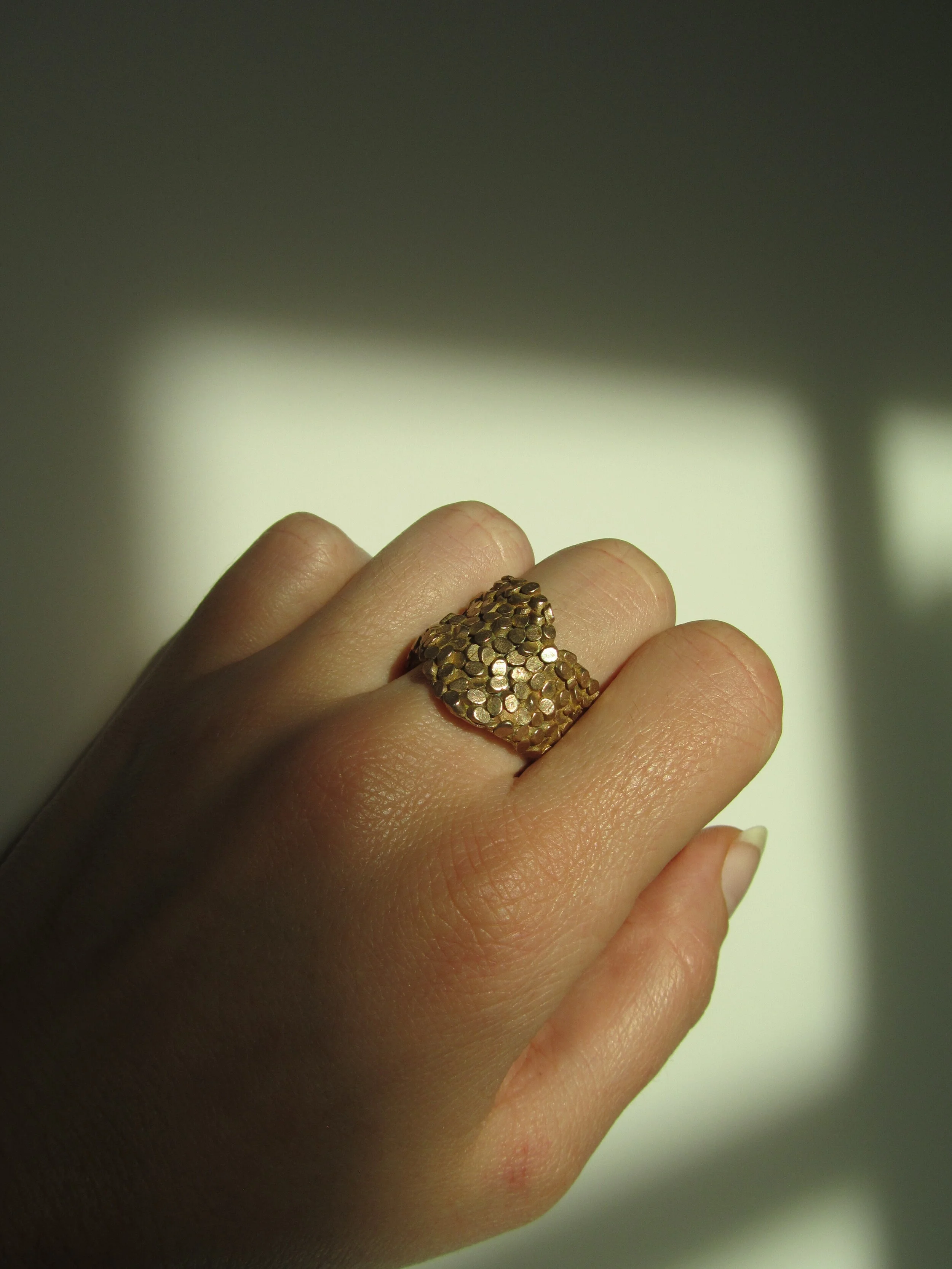 jade mellor caddis ring bronze curvaceous hand wearing.JPG