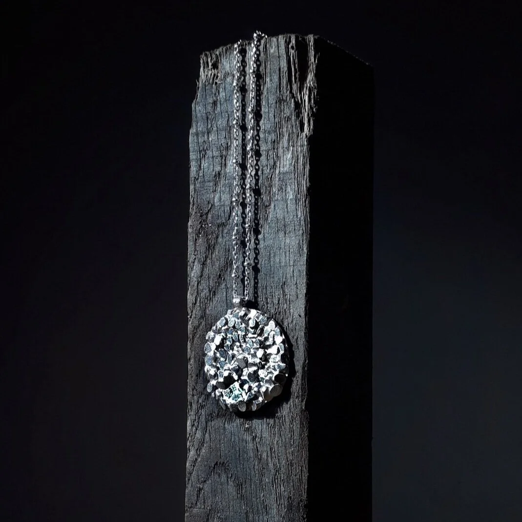 jade+mellor+large+disc+silver+caddis+pendant+black+wood+obelisk.jpg
