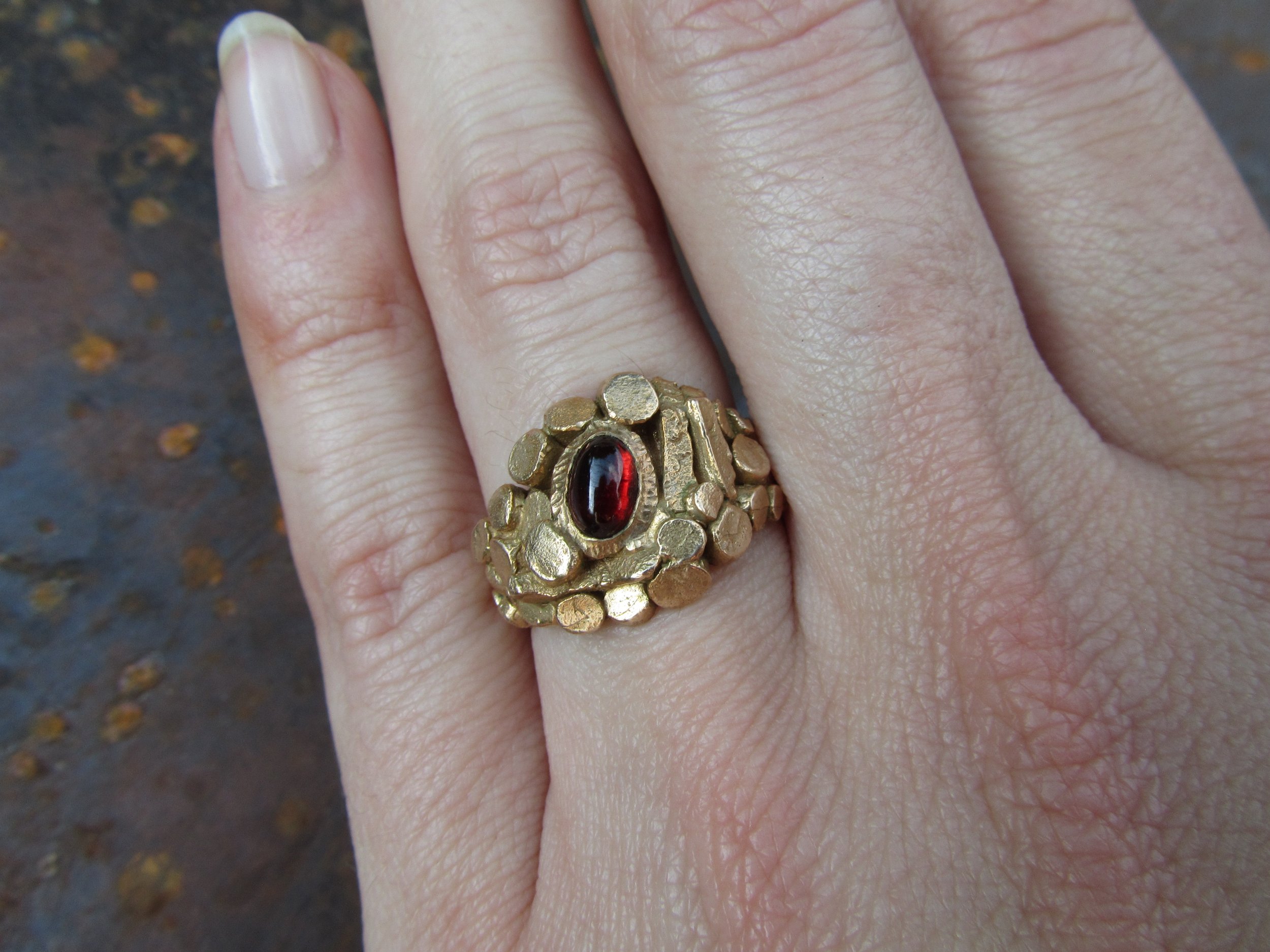 jade mellor garnet bronze caddis cluster ring worn close.JPG