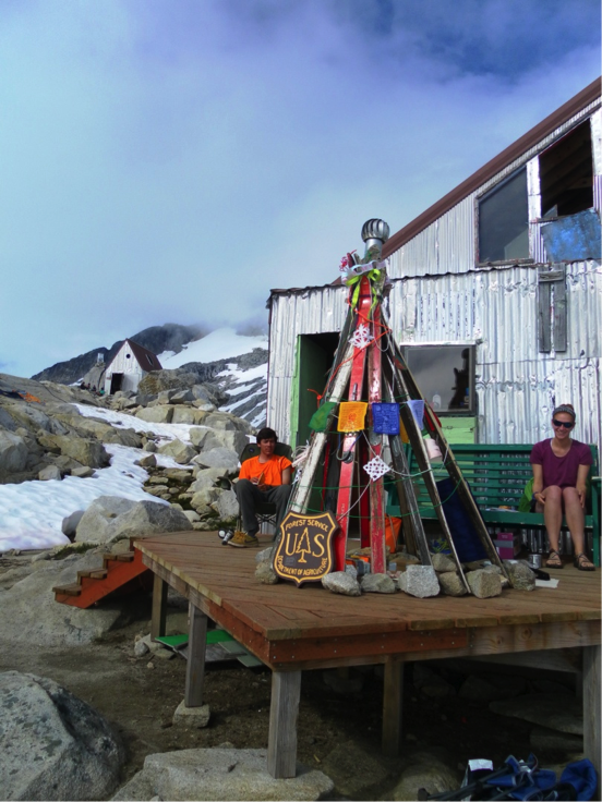 Alexei Doncov, and Leah Nelson enjoying the afternoon sun on the Camp 10 deck with our JIRPmas ski tree. Photo by Muriel Will.