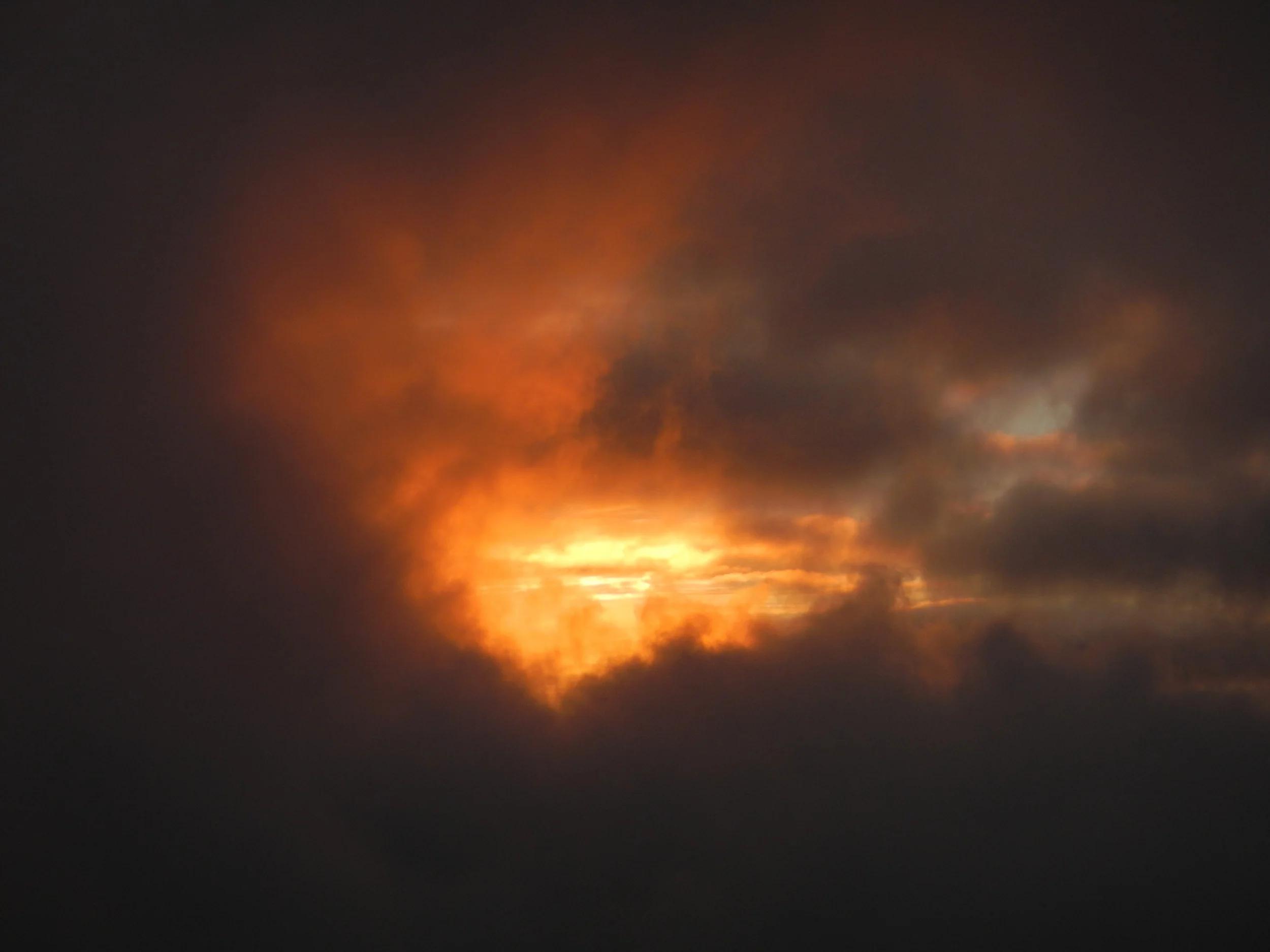 The sun rises through the clouds on the last day at Camp 17. Photo by Natalie Raia