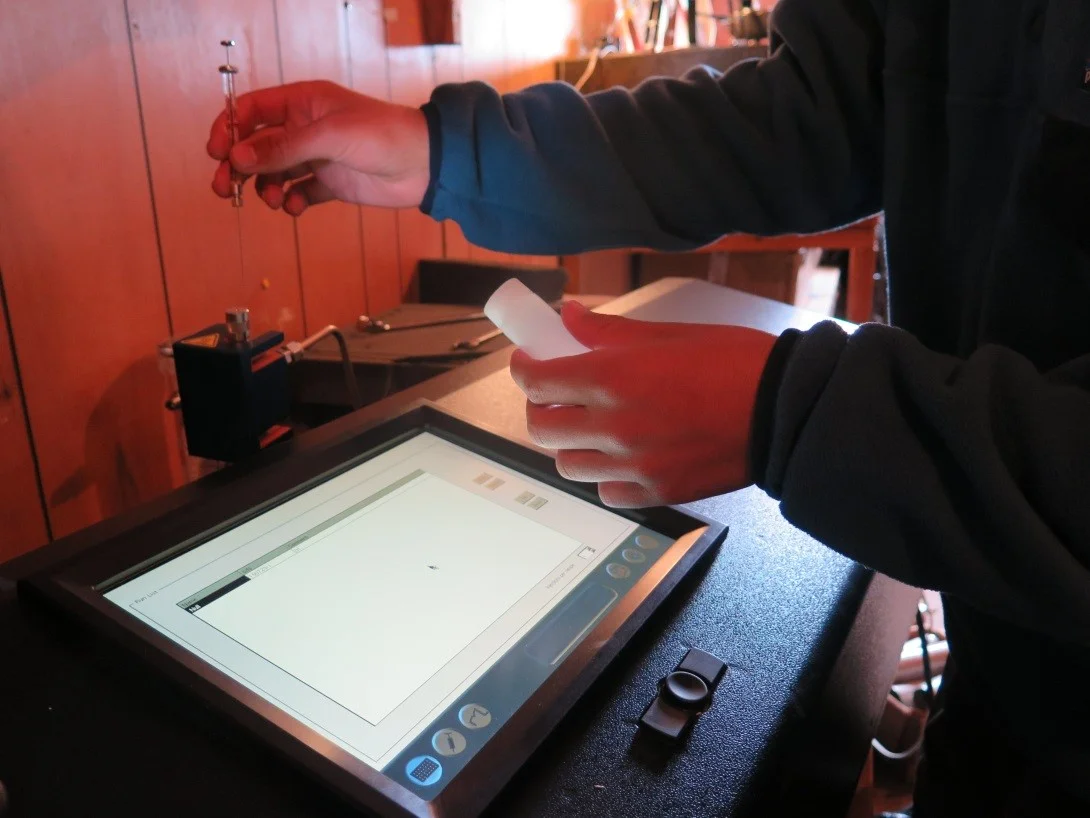 Analyzing rainwater samples using a water isotope analyzer. Photo by Blaire Slavin.