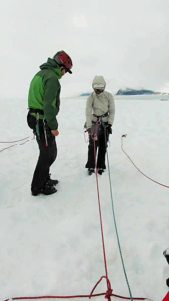 Ari tying her final safety knots with the crevasse opening several meters behind her. Photo by author.