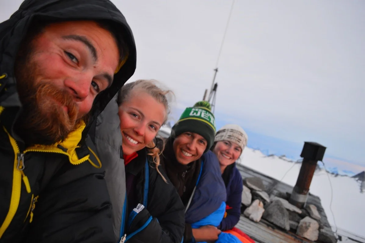 Camp 8 crew enjoying the sunset from the roof. (Photo Credit: Scott Braddock)