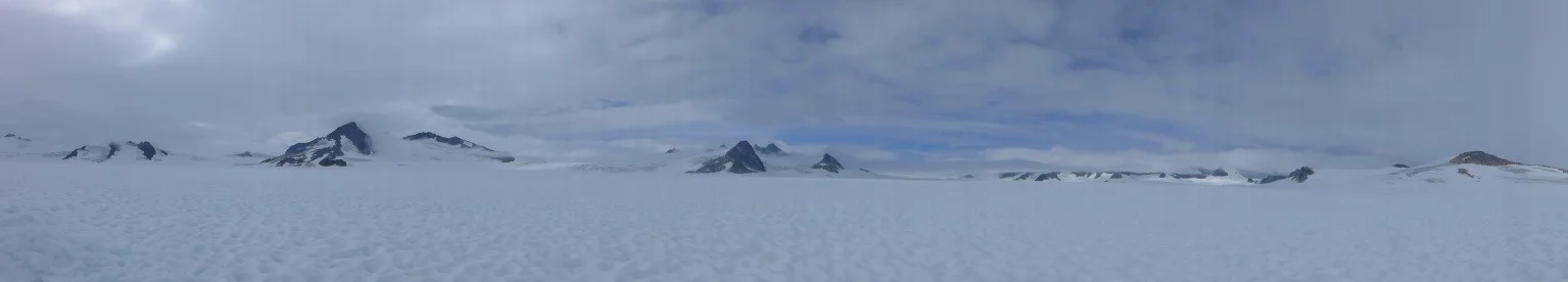 Beautiful nunataks surrounding the pit dug during the second day. Photo by author.