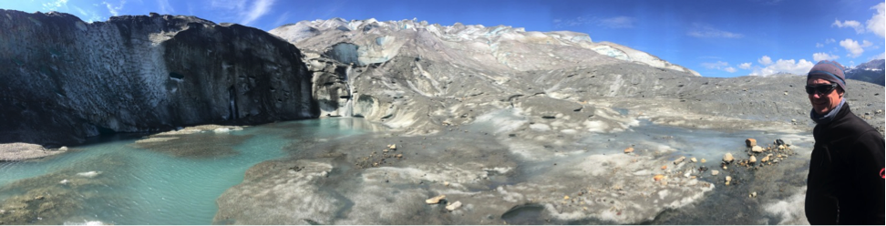 The glacier’s complex hydrology system displays a waterfall emerging near the terminus.