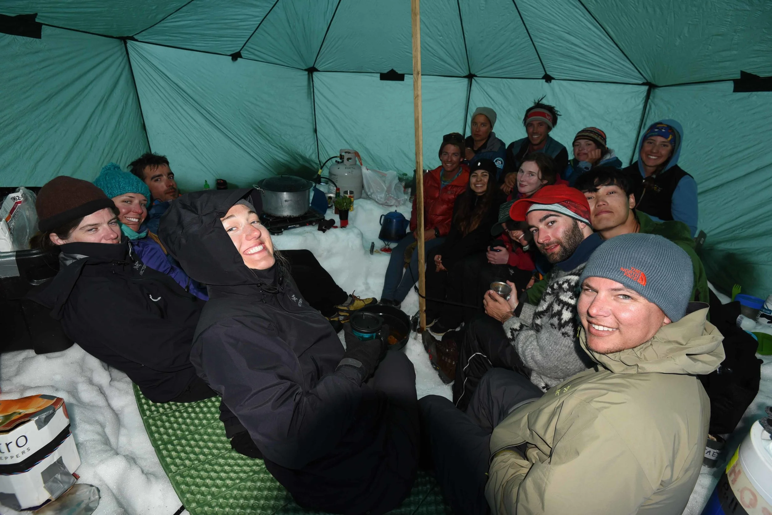 Louise enjoying a hard-won rest with fellow JIRPers at the Norris Cache, halfway through the ski traverse from Camp 17 to Camp 10. Photo courtesy PBJ Photography.
