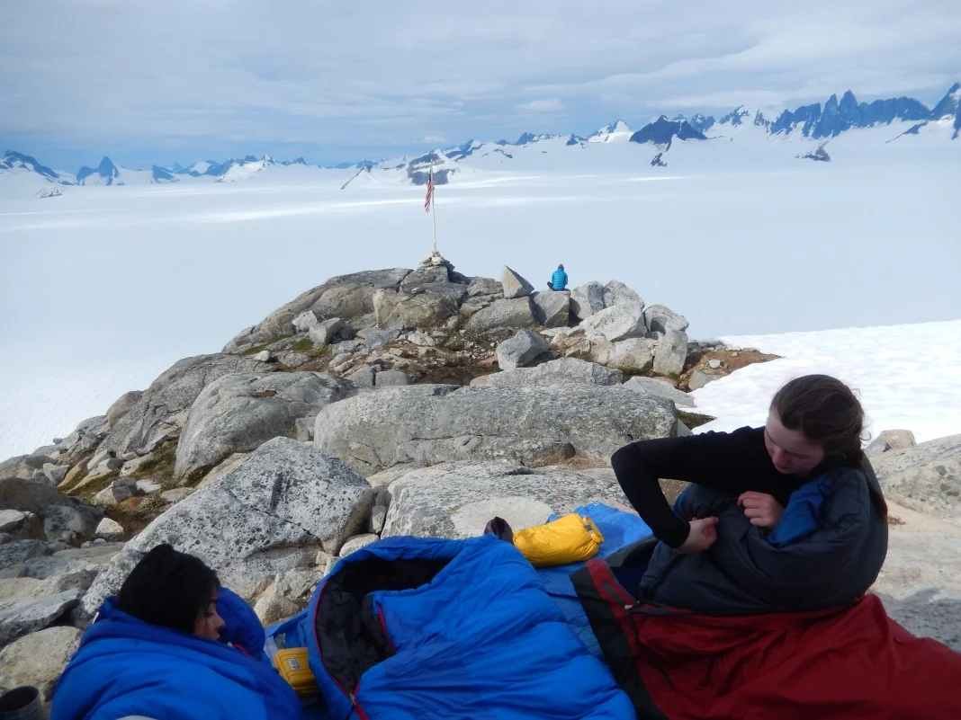 Shawnee Reynoso and Louise Borthwick sleeping out on the porch of the Camp 10 cook shack overlooking Taku Glacier. Photo: Kate Bollen