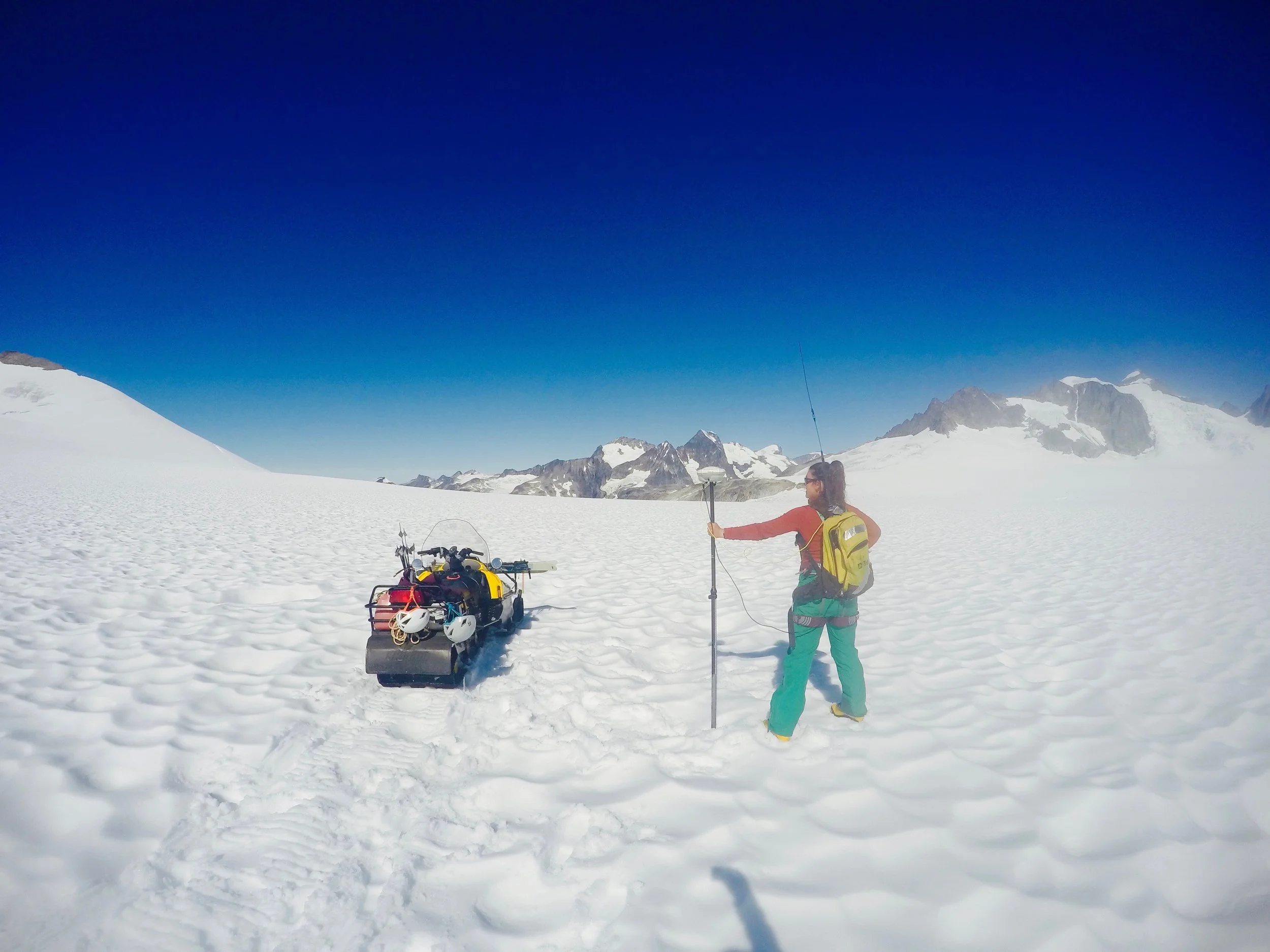 The author with her GPS jet pack! The GPS Rover (looks like a yellow backpack) and the antenna we use to find and re-survey the profile points. With the press of a few buttons it stores the latitude, longitude, and elevation of that particular point. Photo credit Brittany Ooman.