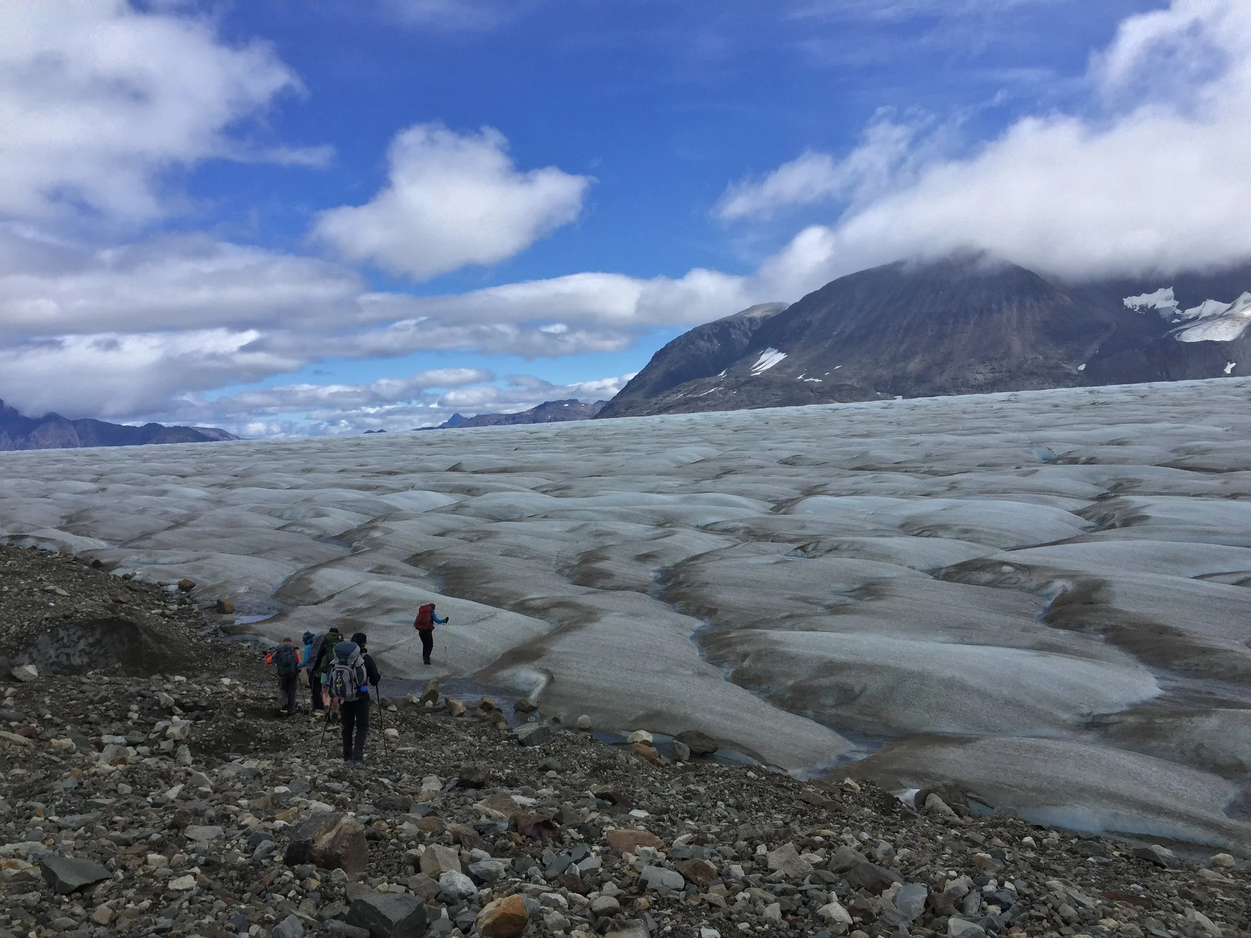 Team BGC crosses from the nunataks to the blue ice of the ablation zone for a day of fieldwork. Photo credit: Auri Clark