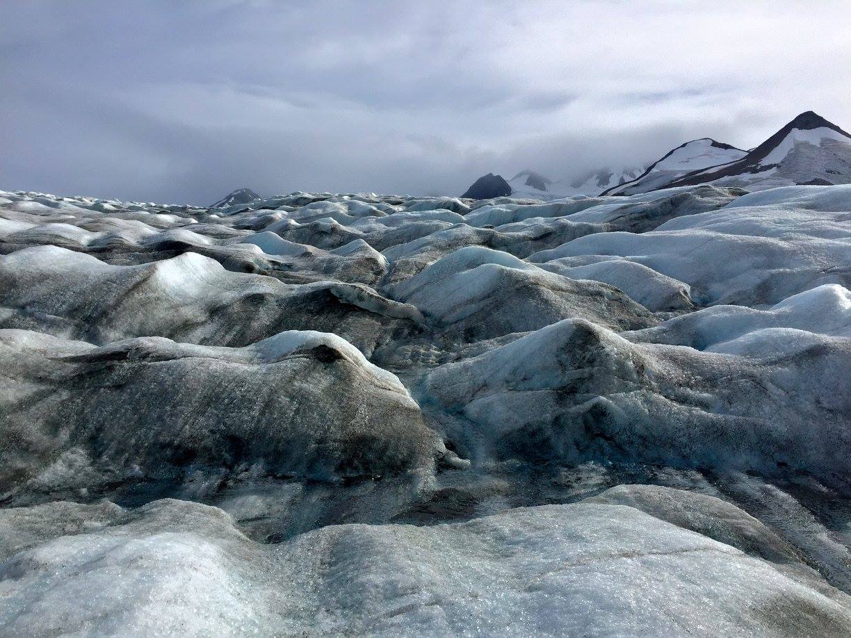A supraglacial stream running over the blue the ice, which our testing showed carries surprisingly low levels of alkalinity. Photo credit: Auri Clark