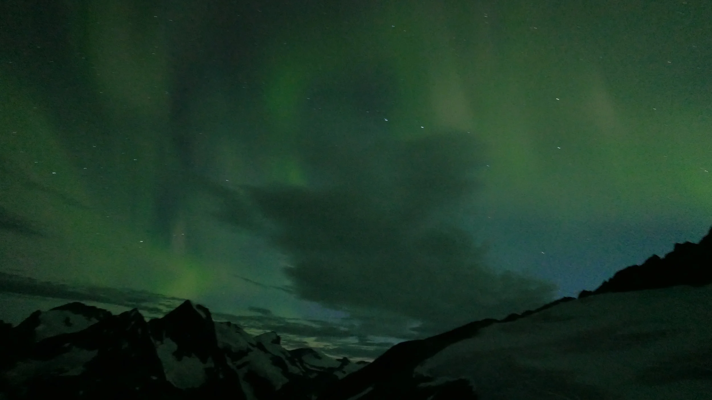 Mountains above the Gilkey Trench under the Aurora Borealis. Photo Credit: Deirdre Collins