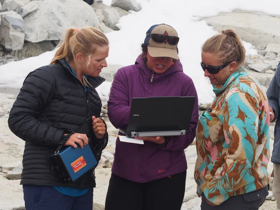 Deirdre Collins, Brittany Ooman, and Kate Bartell discuss reflectance data in the field. Photo by Shawnee Reynoso.