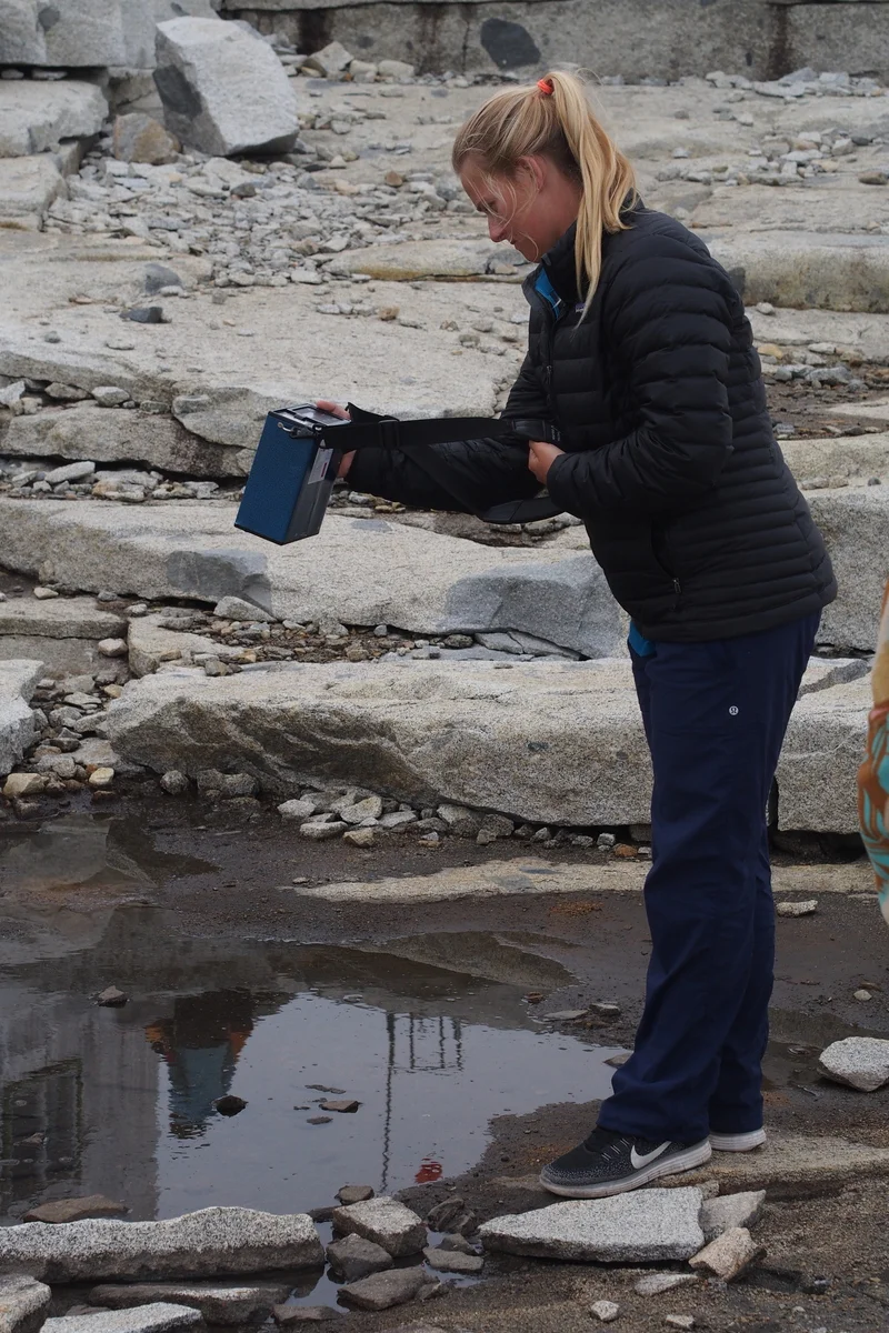Deirdre Collins uses Chuck the Field Spectroradiometer to investigate the reflectance of various surfaces near Camp 18. Photo by Shawnee Reynoso.