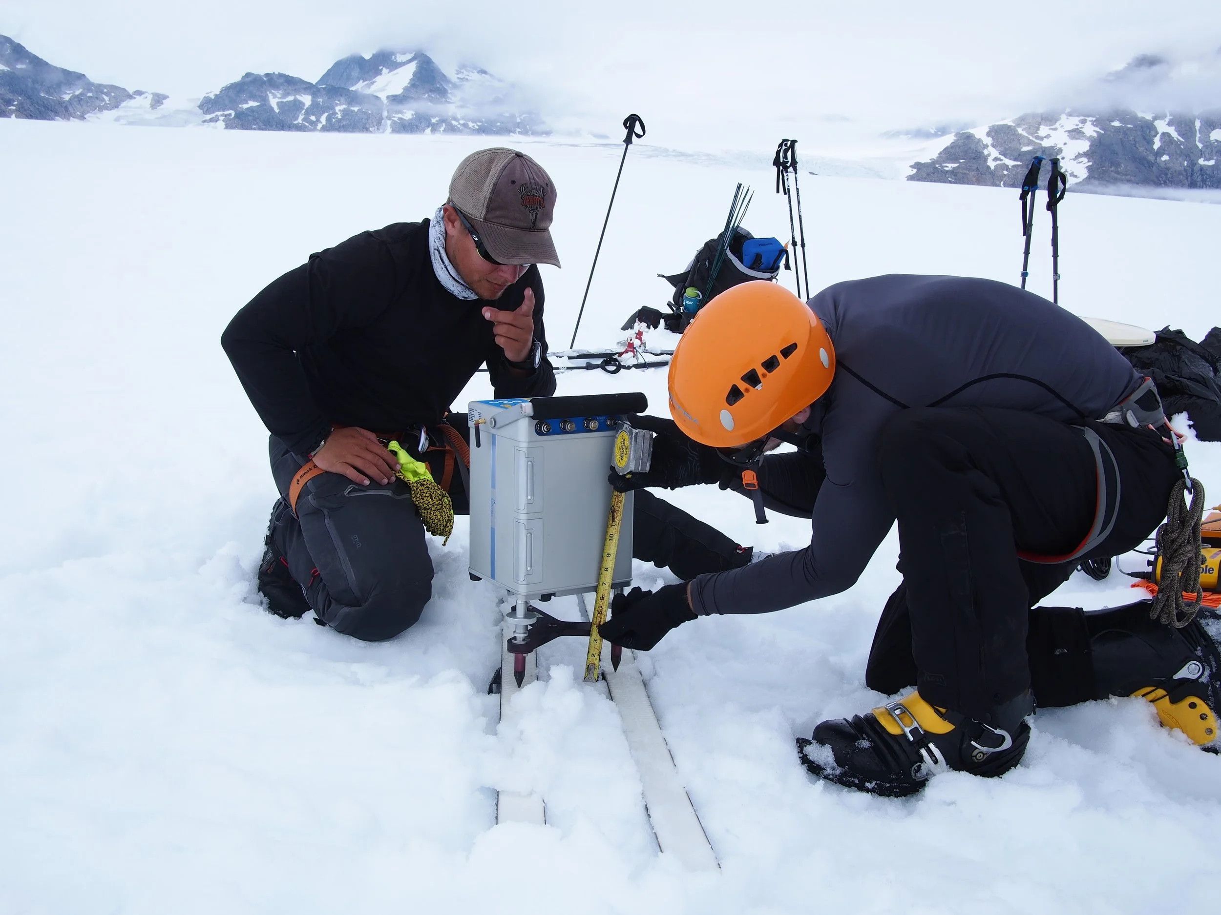 Students DJ Jarrin and Riley Wall set up the delicate gravimeter. The gravimeter measures tiny anomalies in the local gravity, which the students use to deduce information about the bedrock buried beneath almost a mile (1500 m) of ice. Photo credit: DJ Jarrin.