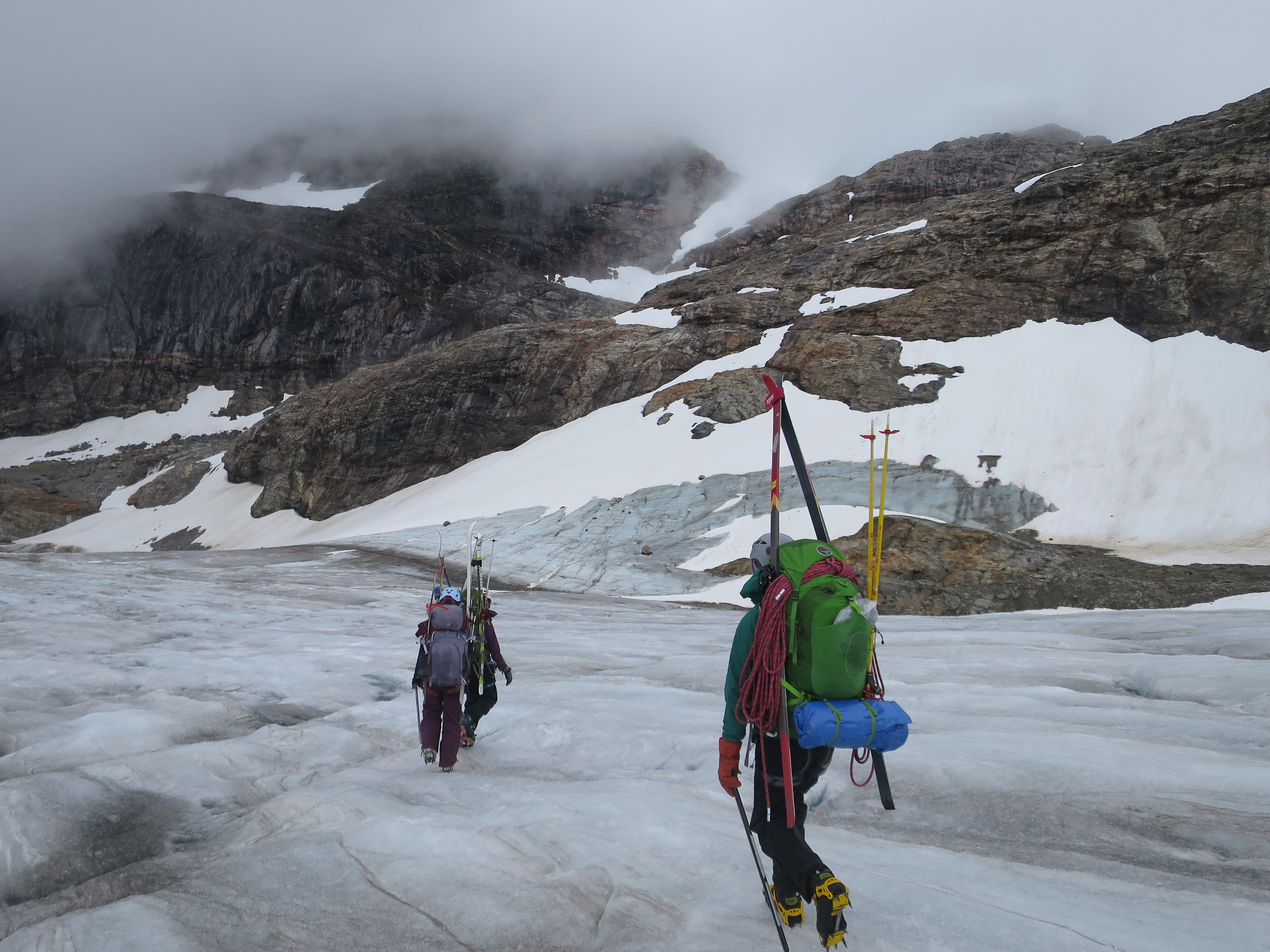 Students Zach Gianotti, Theresa Westhaver, and Ilana Casarez crossing the blue ice at the terminus of the Lemon Creek Glacier before our hike up Nugget Ridge. PC: Bryn Huxley-Reicher