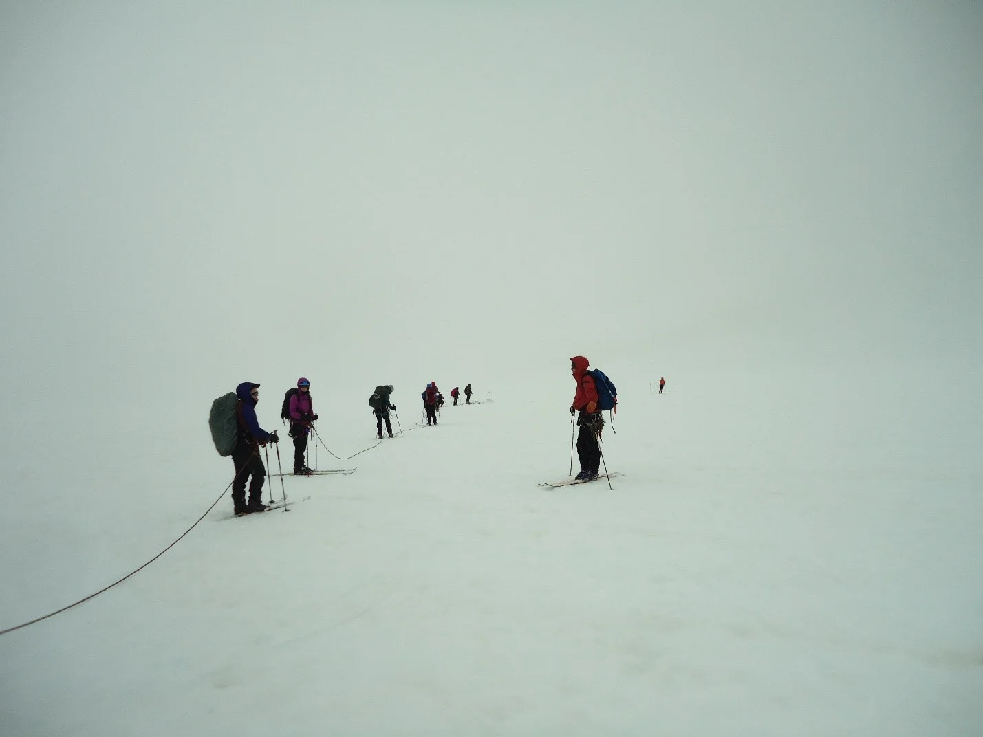 Our first week had a heavy focus on ski training and safe glacier travel practices, which requires learning to “rope up” in case someone in a trail party falls into a crevasse. This way, if someone were to fall in, everyone else on the rope team drops to the ground to prevent a long fall and prepare the next stages of rescue. Photo credit: Kelcy Huston.