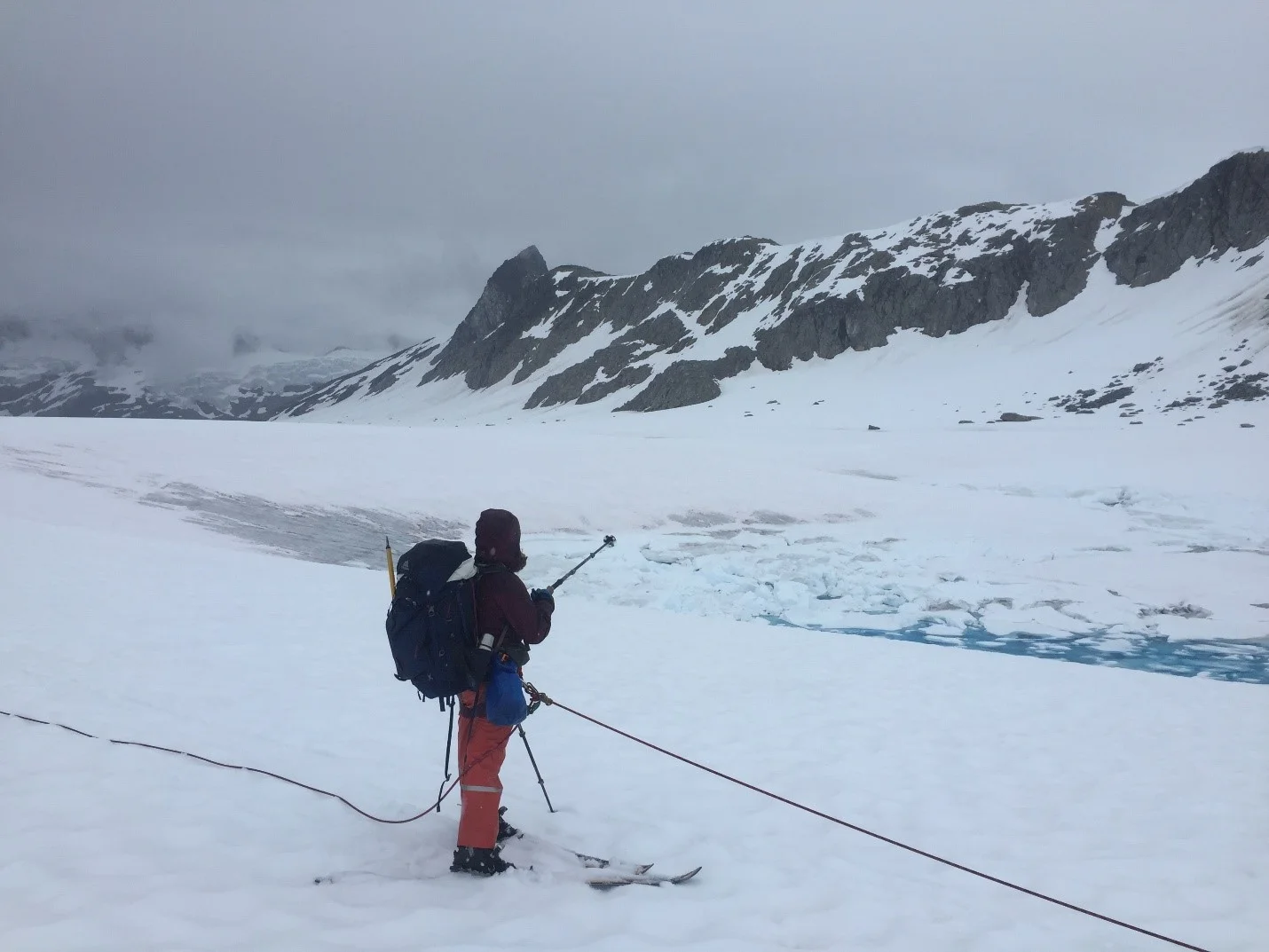 Staffer Annika Ord pointing out a snow swamp during the trip to Avalanche Canyon. Photo credit: Susannah Cooley.