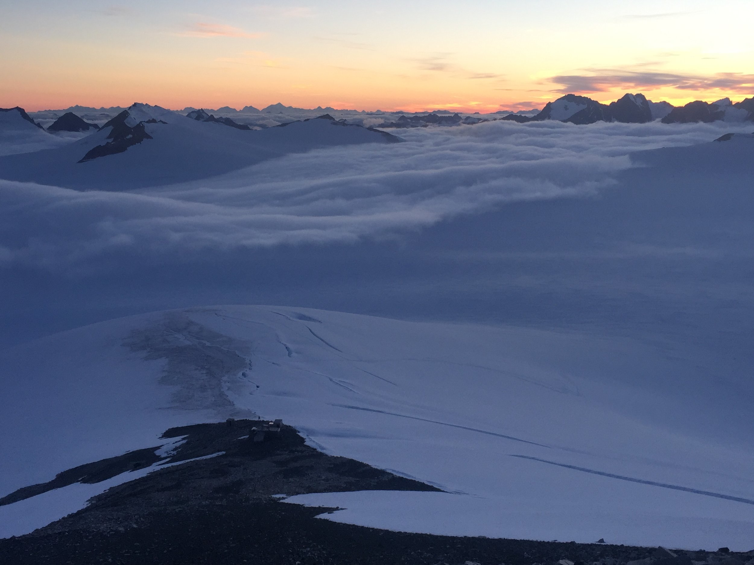  View of C8 and the upper Matthes Glacier from Mt. Moore at sunset, with C18 below the clouds. Photo: Amy Towell. 