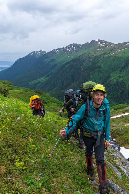 Student Eric Keenan hikes up to Camp 17 with a full size backpack during the first week of JIRP. Check out the mountains in the background- the terrain is steep- but the trail we go up follows a sensible route. PC: Daniel Otto.