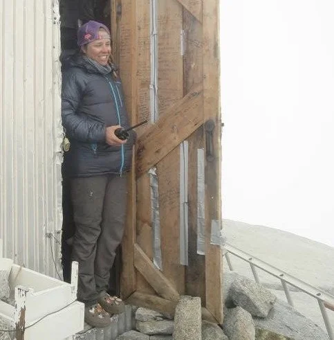 Lara emerges from the Camp 9 Cookshack to make a phone call.