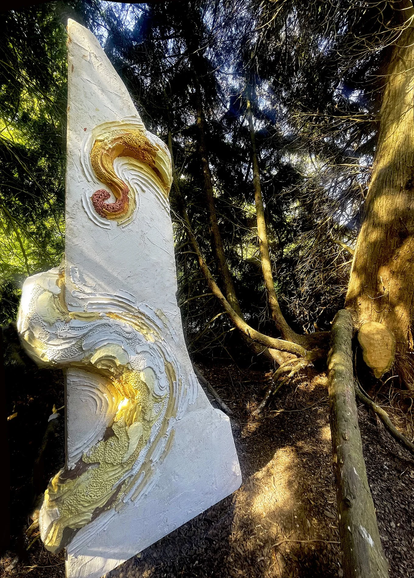 Large scale monumental scultpure made of concrete and colored mortar with extreme organic details depicting a monumental octopus wrapped arouind an architectural colummn  in a private sculpture park owned by a contemporary art collector and a museum