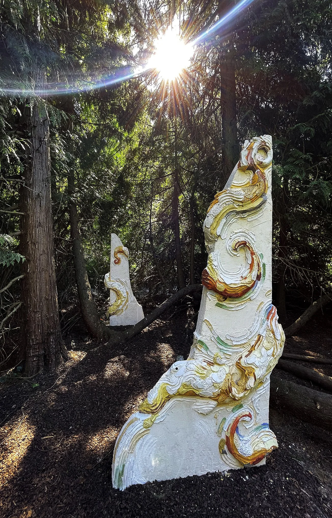 Large scale monumental scultpure made of concrete and colored mortar with extreme organic details depicting a monumental octopus wrapped arouind an architectural colummn  in a private sculpture park owned by a contemporary art collector and a museum