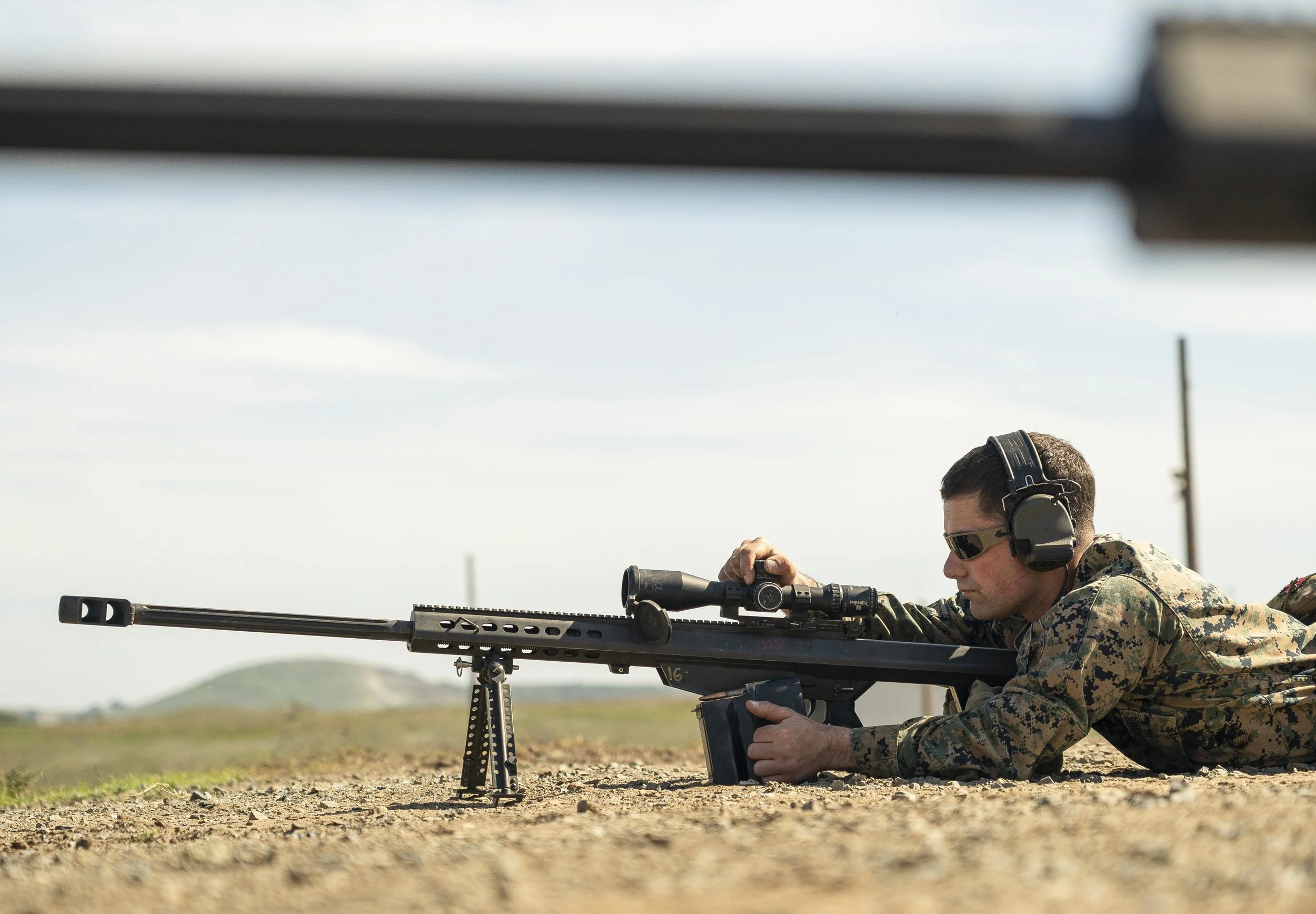  A student in the Reconnaissance Sniper Course adjusts his ATACR 5-25x56 SFP ENHANCED Riflescope on the .50 caliber M107 Special Application Sniper Rifle (SASR) during known-distance marksmanship training on Camp Pendleton Feb. 11. Photo by Ethan E. 
