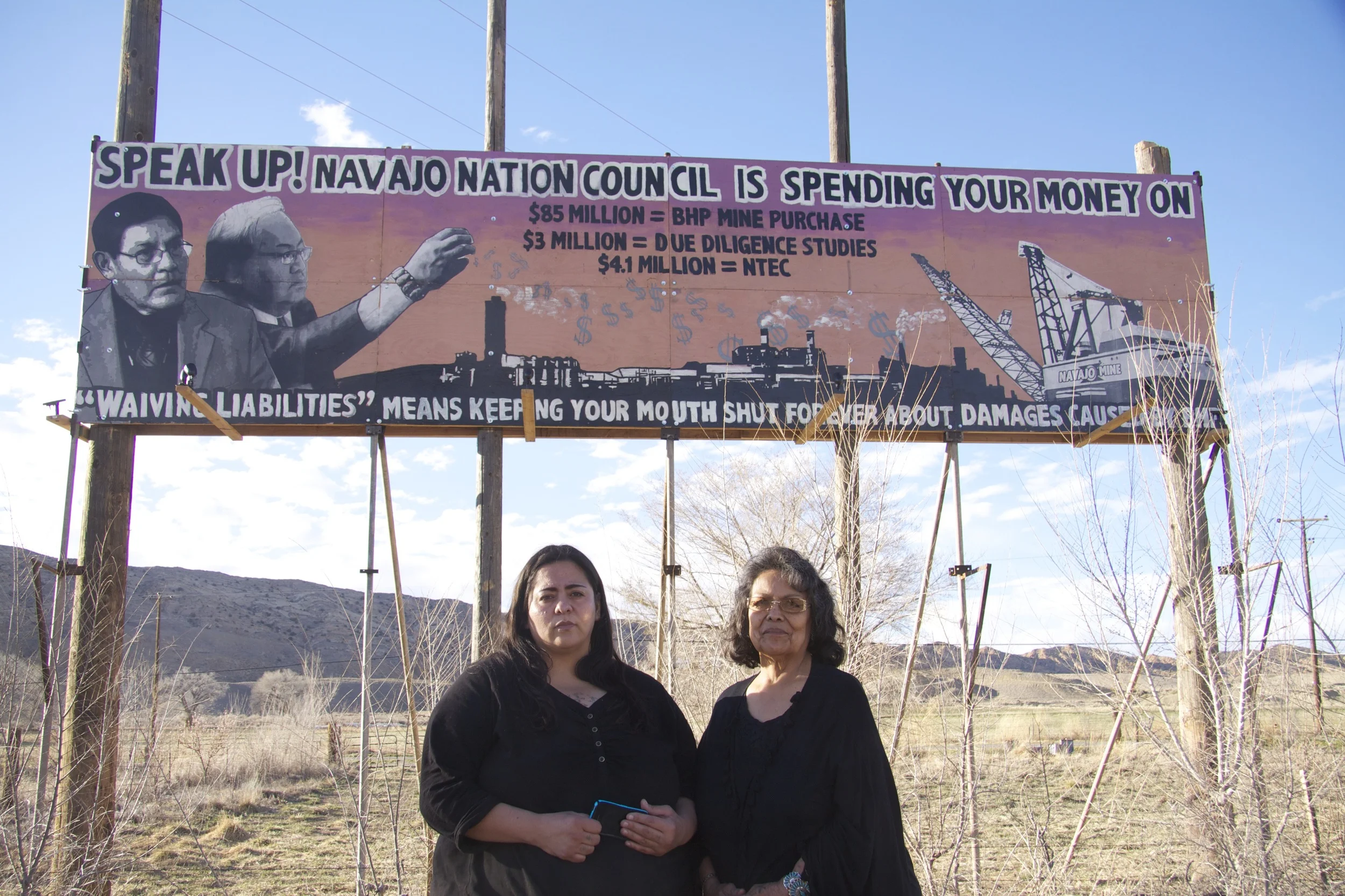Navajo anti-coal activists Victoria Gutierrez and Sarah Jane White and the billboard they erected on U.S. Highway 64 between Shiprock and Farmington, N.M. 