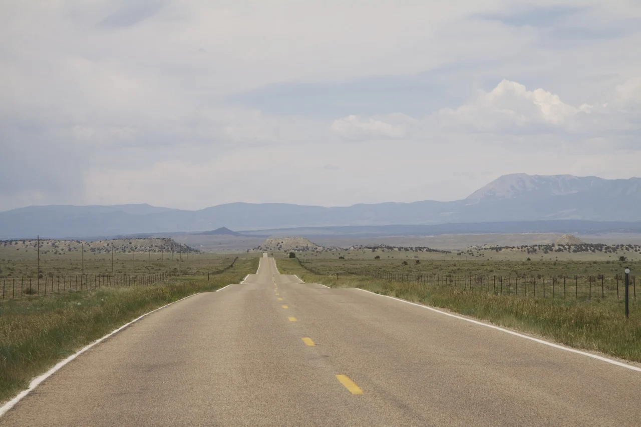 Colorado Highway 10 looking west towards Walsenburg, 13 miles east of I-25. This is not on the list of most scenic highways in the state, but a highway threading through similar country not far to the southeast is on the list. © 2012 by Bobby Magill.