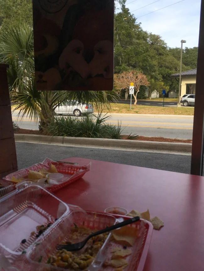 The McLeod Plantation's slave quarters appear across Folly Road from a burrito joint in a strip mall, where thousands shop at Harris Teeter and CVS every day. © Bobby Magill