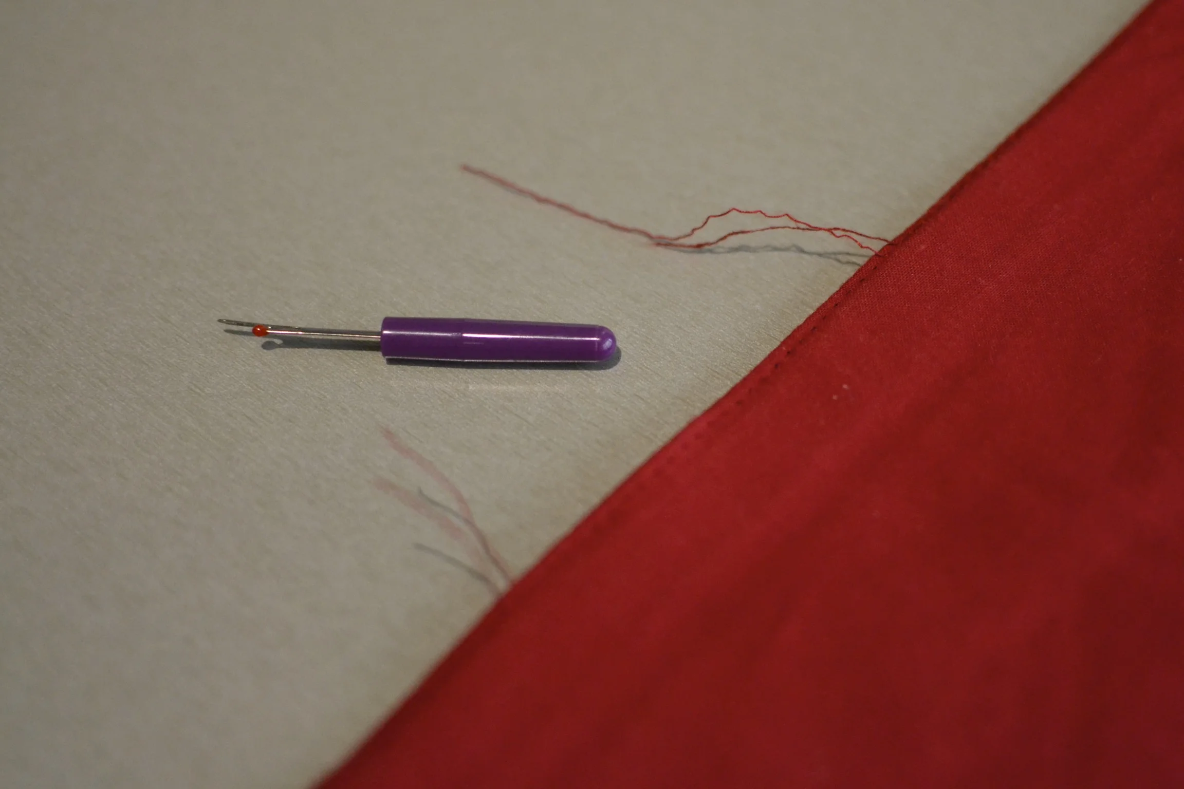 once you have created an opening about 6" wide, pull both lengths of thread through to the back and double tie them off before trimming. this will prevent the seem from opening any further. 