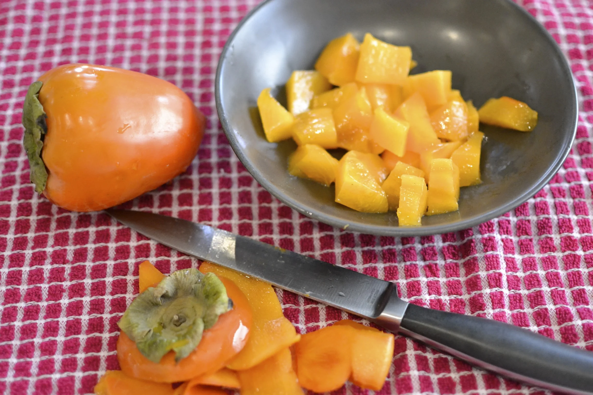 while the crust is baking, you have time to start working on the filling. i love the color of these persimmons! 